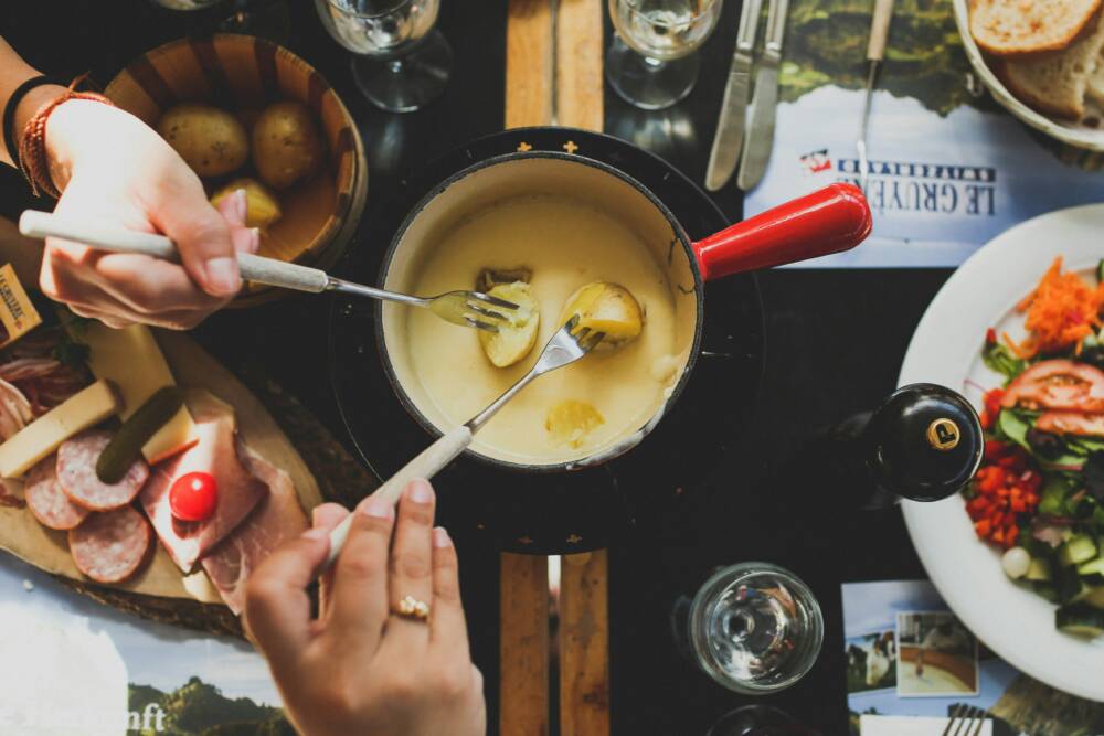 Im November und Dezember wird es mit zart schmelzendem Käsefondue bei Hygge – The Farm so richtig gemütlich /©unsplash / Angela Pham